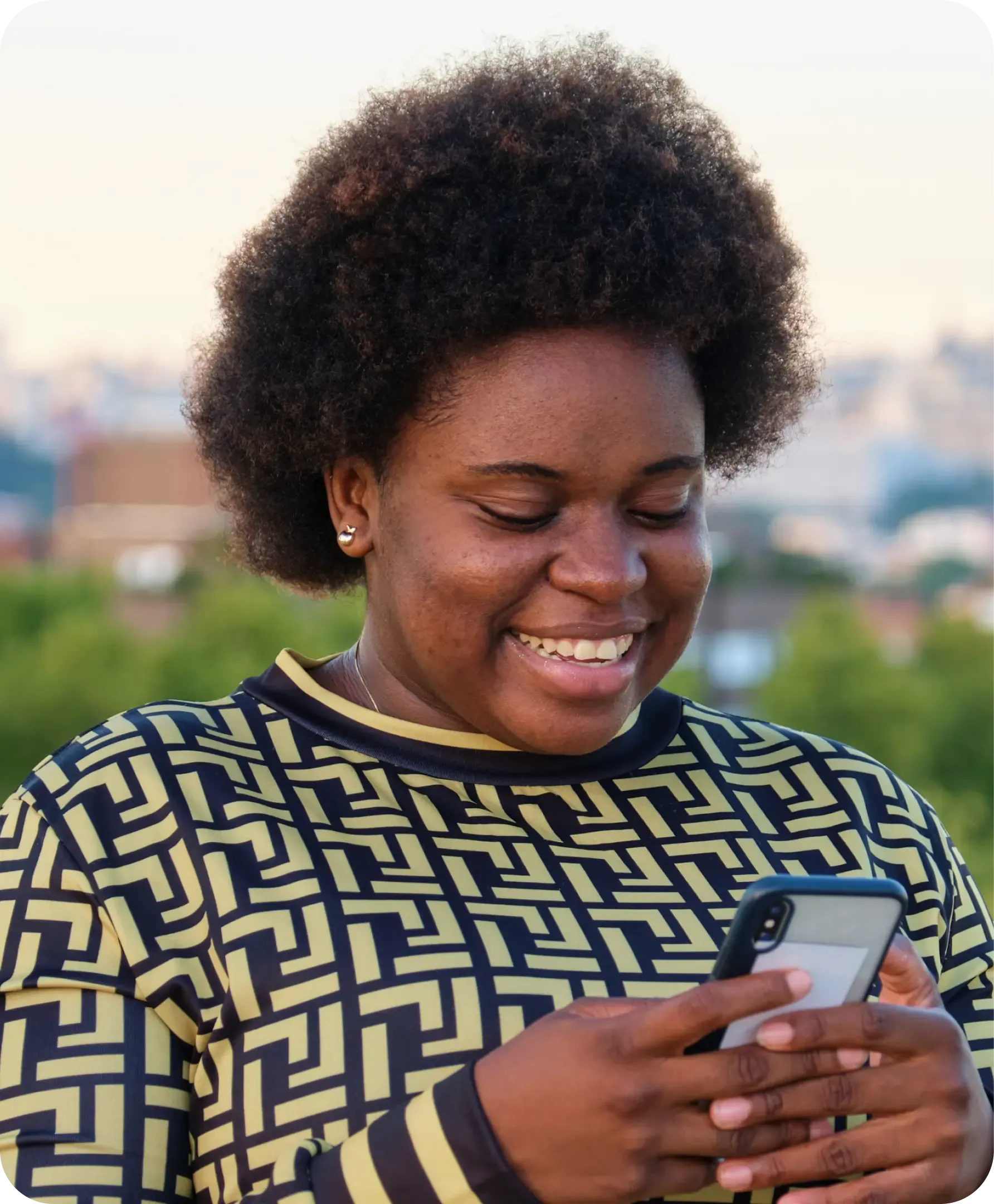 Woman smiling while receiving money on her phone